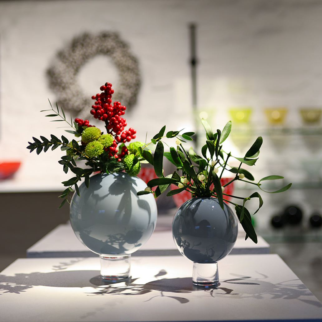 hand blown grey round vases with Christmas arrangements of Mistletoe and Ilex