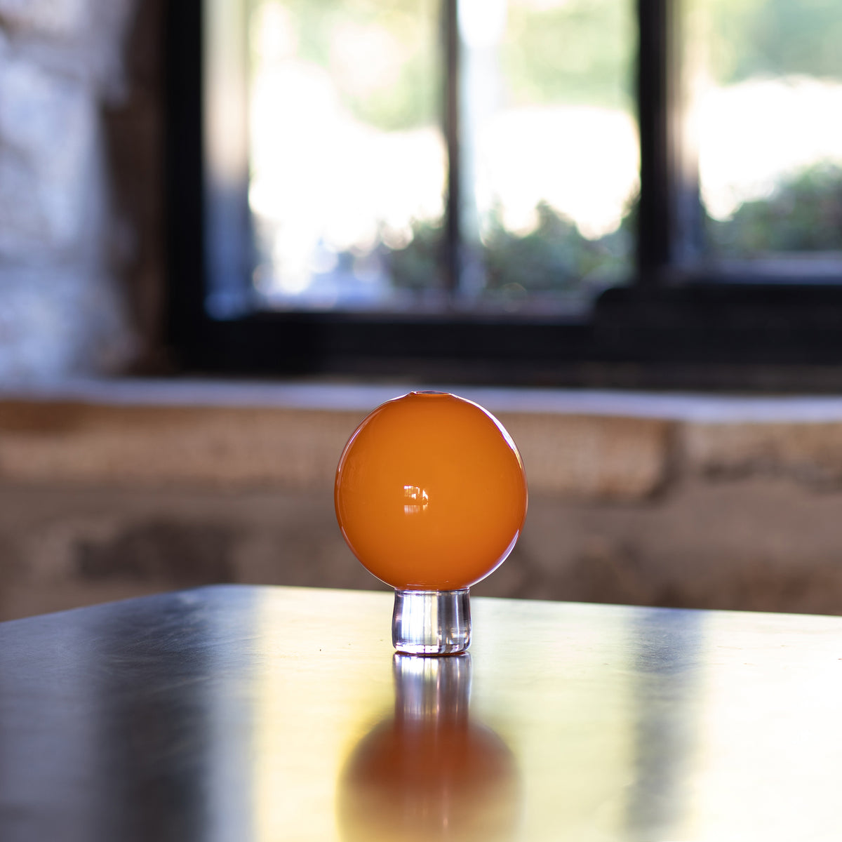 small hand blown opaque orange glass vase for a single bloom or small posey of flowers